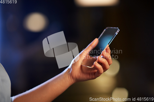 Image of close up of hand with transparent smartphone