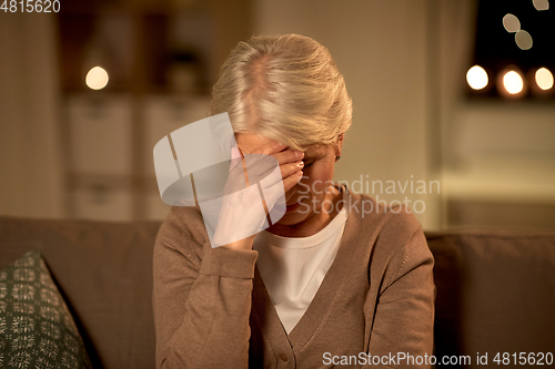 Image of unhappy senior woman suffering from headache