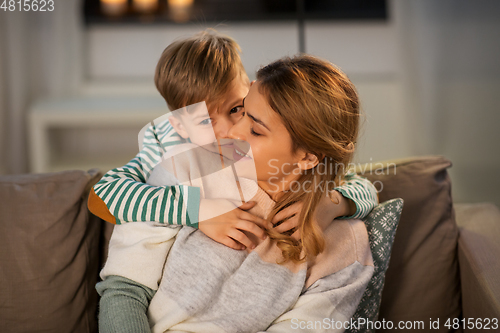 Image of happy smiling mother and son hugging at home