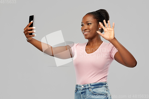 Image of african american woman taking selfie by smartphone