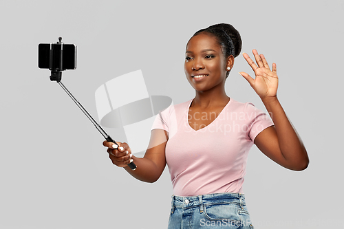 Image of african american woman taking selfie by smartphone