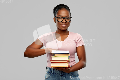 Image of happy african american woman with books