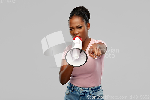 Image of angry african american woman over grey background