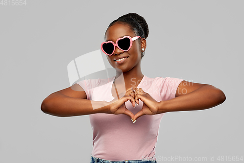 Image of african american woman in heart-shaped sunglasses