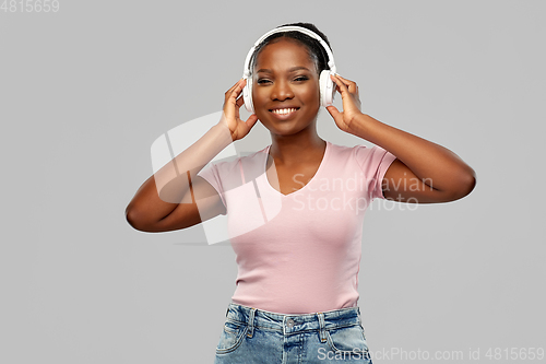 Image of african woman in headphones listening to music