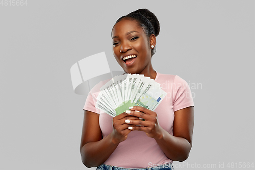 Image of happy african american woman with euro money