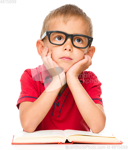 Image of Little boy is reading a book