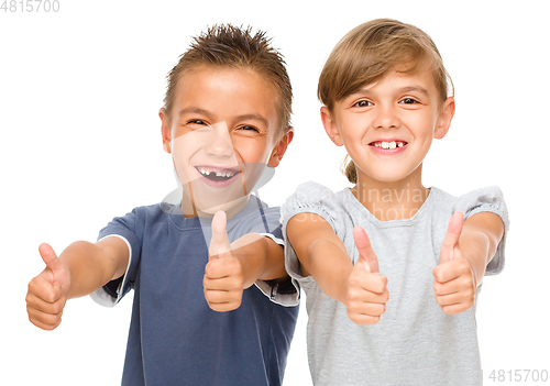 Image of Little boy and girl are showing thumb up sign