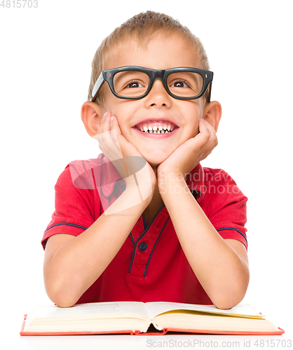 Image of Little boy is reading a book