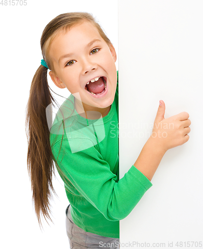 Image of Little girl is looking from out blank board