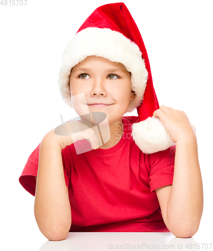 Image of Portrait of a cute little girl in santa hat