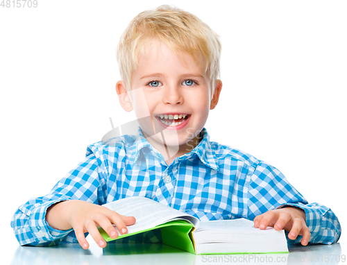 Image of Little child play with book