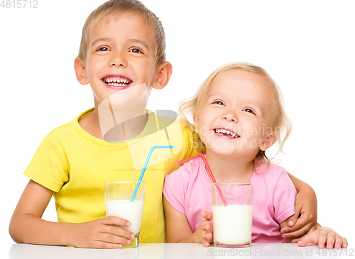 Image of Cute little girl and boy are drinking milk