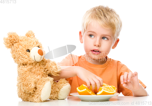 Image of Portrait of a little boy with his teddy bear