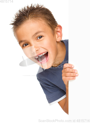 Image of Little boy is looking out from the blank banner