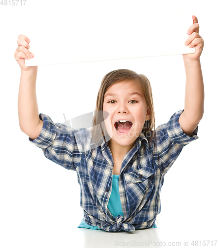 Image of Little girl is holding a blank banner