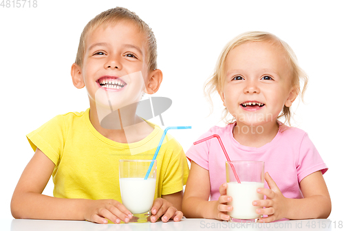 Image of Cute little girl and boy are drinking milk