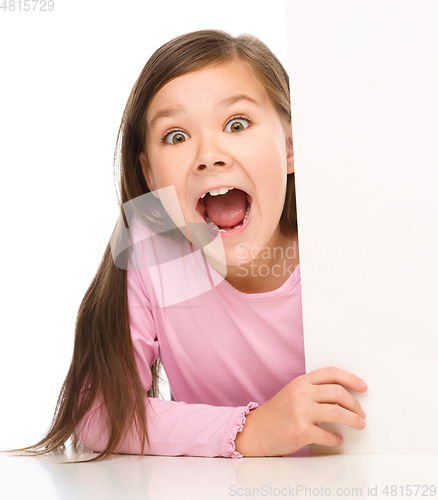 Image of Little girl is looking from out blank board