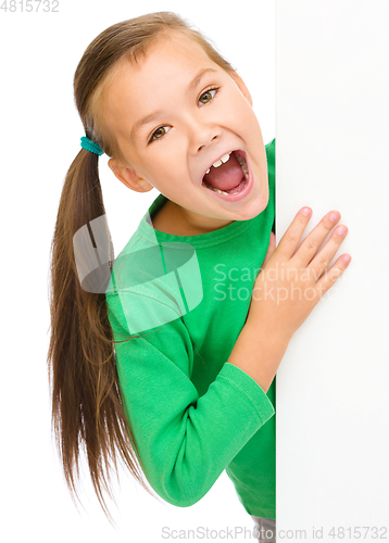 Image of Little girl is looking from out blank board