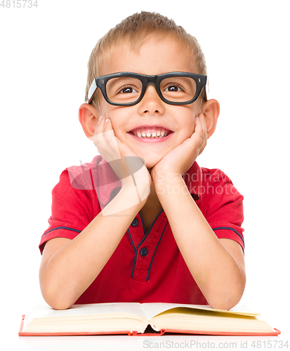 Image of Little boy is reading a book