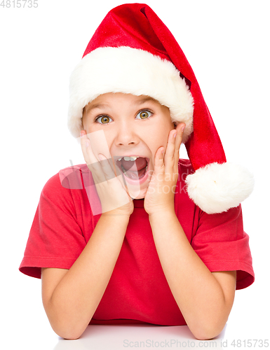 Image of Little girl is holding her face in astonishment