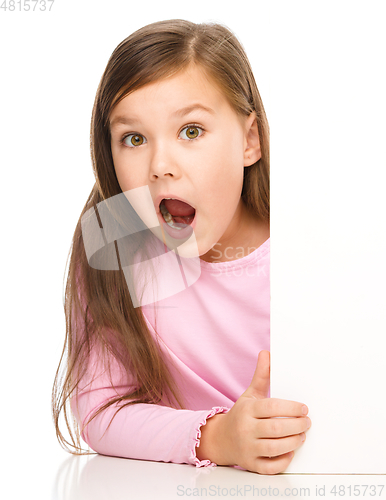 Image of Little girl is looking out from the blank banner