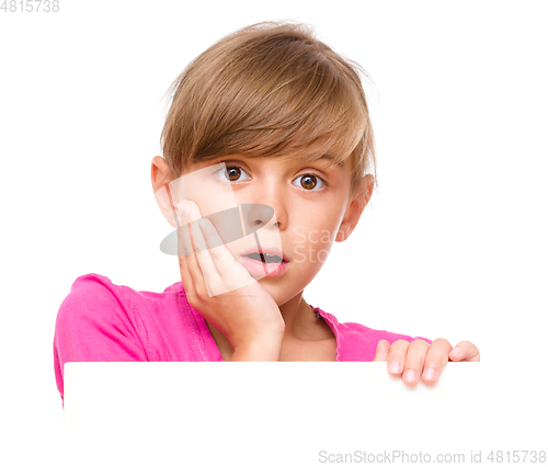 Image of Little girl is looking out from the blank banner