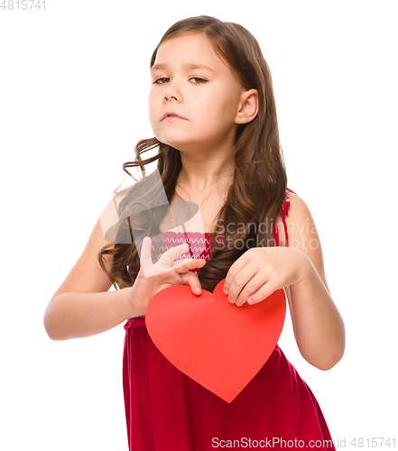 Image of Portrait of a sad little girl in red