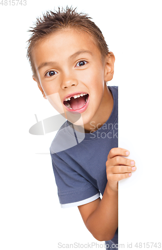 Image of Little boy is looking out from the blank banner