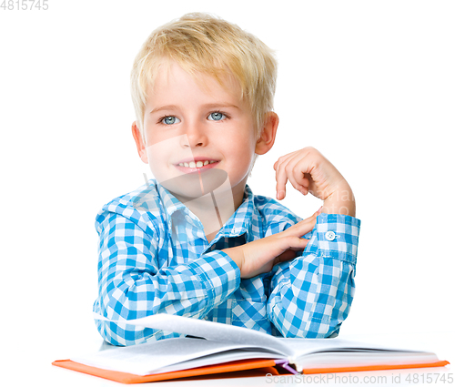 Image of Little child play with book