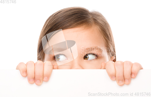 Image of Little girl is looking from out blank board