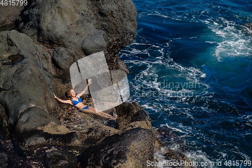 Image of beautiful girl resting in natural ocean swimming pool