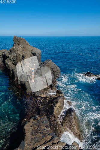 Image of beautiful girl resting in natural ocean swimming pool