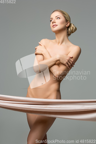 Image of beautiful naked woman with silk fabrics covering intimate zone