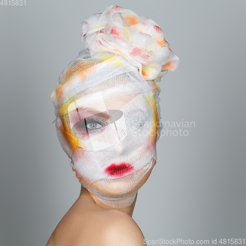 Image of girl with heavy makeup and bandage on head