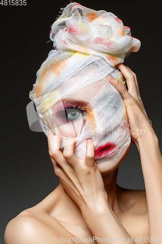 Image of girl with heavy makeup and bandage on head