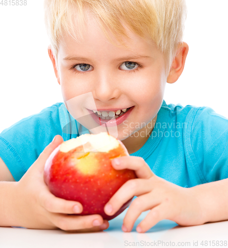 Image of Portrait of a cute little boy with red apple