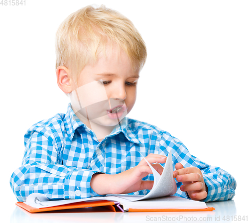 Image of Little child play with book