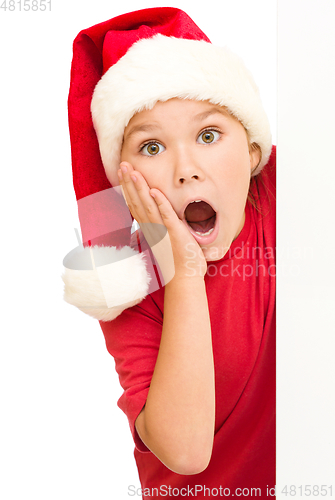 Image of Little girl is holding her face in astonishment