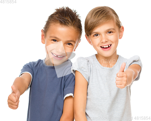 Image of Little boy and girl are showing thumb up sign
