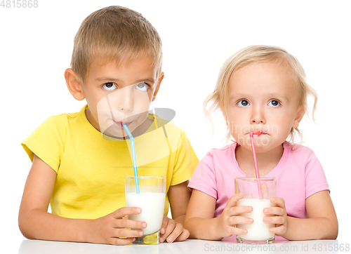 Image of Cute little girl and boy are drinking milk