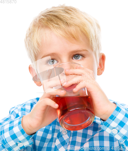 Image of Little boy with glass of cherry juice
