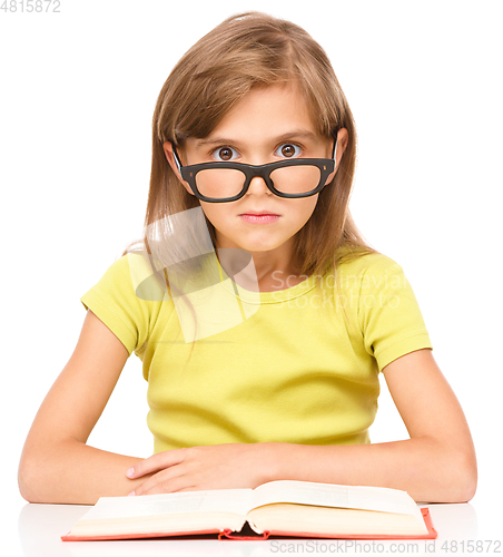 Image of Little girl is reading a book