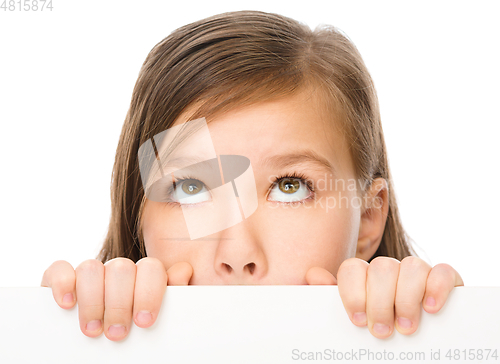 Image of Little girl is looking from out blank board