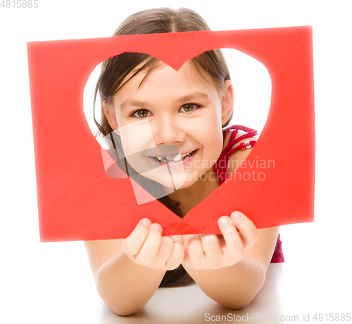 Image of Little girl is looking through heart template