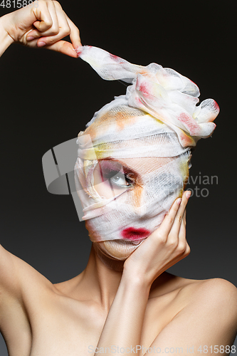 Image of girl with heavy makeup and bandage on head