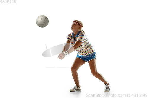 Image of Senior woman playing volleyball in sportwear on white background