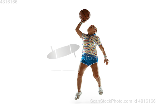 Image of Senior woman playing basketball in sportwear on white background