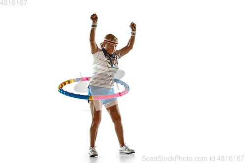 Image of Senior woman training with hoop in sportwear on white background