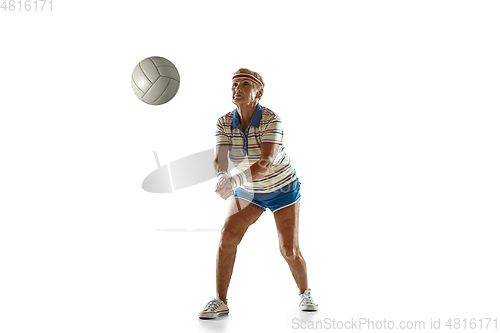 Image of Senior woman playing volleyball in sportwear on white background